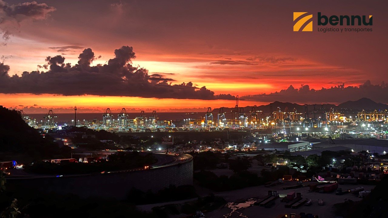 Vista aérea del puerto de Manzanillo al atardecer, con grúas y contenedores en operación